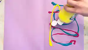 Pulled String Art Activity Squeezing Paint onto paper