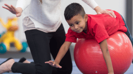 An occupational therapist working with a young child